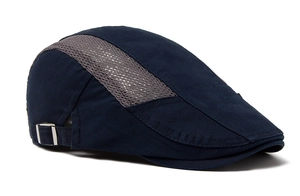 Detail of navy blue flat cap featuring breathable grey mesh and metal side buckles