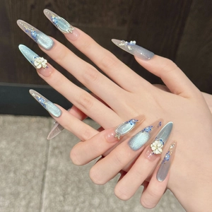 Blue cat eye press-on nails with 3D white flowers and pearls in stiletto shape