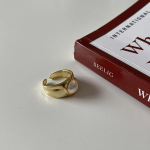 Detail of minimalist 18k gold plated S925 silver open ring with white pearl inlay