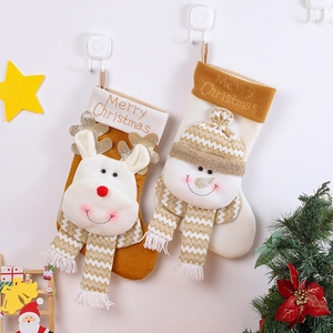 Christmas stockings featuring plush reindeer and snowman designs with Merry Christmas embroidery