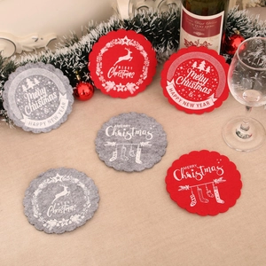 Festive red and grey felt Christmas coasters with wavy edges and holiday patterns