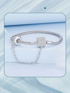 Close-up of S925 sterling silver snake chain bracelet with pave zircon cylinder clasp