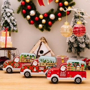 Detailed view of Christmas truck-shaped tin candy boxes with Santa Claus and tree patterns
