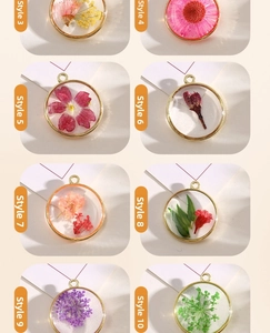 Macro view of eight dried flower resin pendants with gold alloy frames in a grid layout