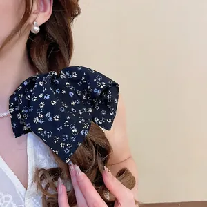 Floral print oversized bow hair scrunchie in navy blue fabric for elegant ponytail styling