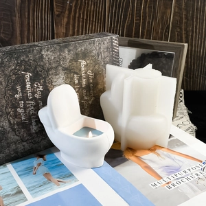 Detail of toilet shaped silicone mold and finished aromatherapy candle on desk