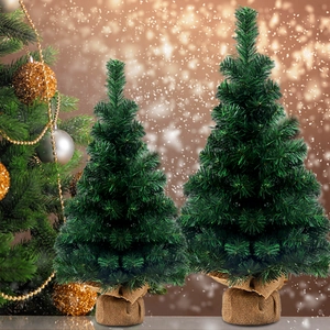 60cm minimalist mini artificial Christmas tree with burlap base in warm festive bokeh