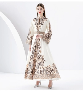 Front view of model in white bohemian floral dress with stand collar and flared sleeves