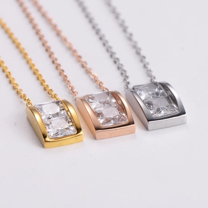 Three rectangular stainless steel necklaces with sparkling square crystals in gold and silver