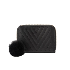 Black V-quilted faux leather coin purse with a soft pompom keychain on white background