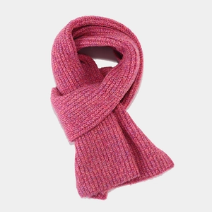 Detailed view of thick knitted scarf in vibrant rose pink with mixed stripe textures