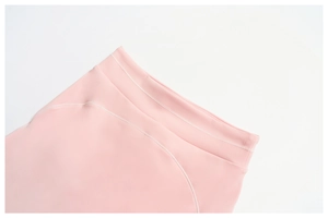 Close-up of pink brushed wide-leg pants showing premium flatlock stitching and fabric