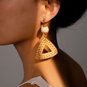 Bohemian rattan triangle drop earrings with wooden beads and woven ball on model