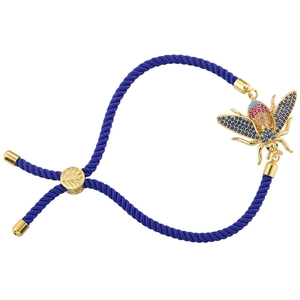 Detail of dark blue woven bracelet with golden bee charm and multicolor cubic zirconia