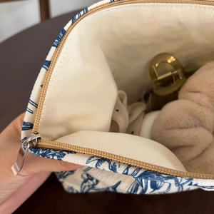 Close-up of floral canvas cosmetic bag showing durable lining and silver metal zipper