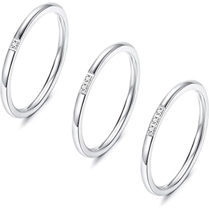 Close-up of three stackable silver rings featuring pave-set rectangular zircon details