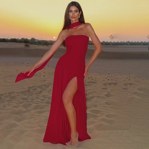 Detail of red strapless maxi dress featuring a high side slit and matching elegant neck scarf