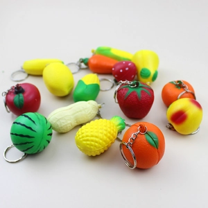 Close-up of various mini fruit and vegetable PU foam squishy keychains with metal chains