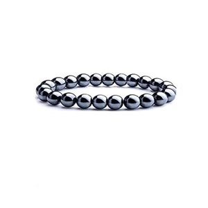 Macro shot of polished round hematite beads bracelet on a white background