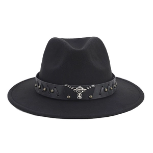 Close-up of black fedora with leather band featuring silver bull head and metal studs