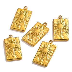 Detailed macro view of five 18K gold plated stainless steel tarot sun pendants