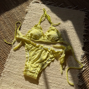 Detailed embroidery on lemon yellow bikini with 3D white flowers and halter ruffles