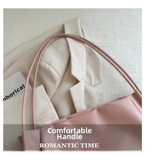 Pink leather tote bag with slim shoulder straps styled with a white blazer and book
