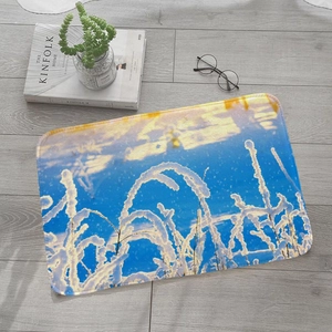 Absorbent flannel rug featuring a winter snow scene on light grey wood flooring