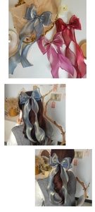 Detail of mermaid pearl organza bow hair clip with long ribbons in multiple colors