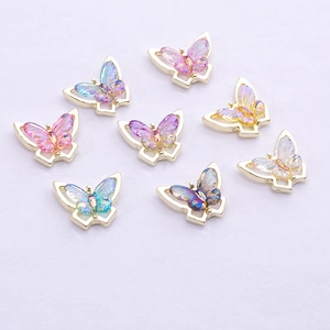 Macro detail of eight aurora butterfly charms with gold metal frames for nail art DIY