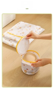 Detail showing hand placing a bra into the cartoon bear printed mesh laundry bag