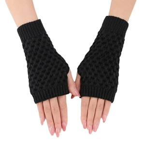 Hand wearing black crochet pineapple stitch fingerless gloves on a white background