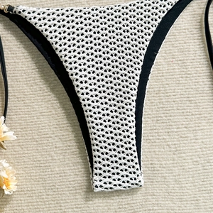 Detailed view of the hollow mesh fabric and black tie-side straps on the bikini bottom