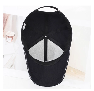 Detailed interior of a black baseball cap featuring branded fashion tape and inner lining