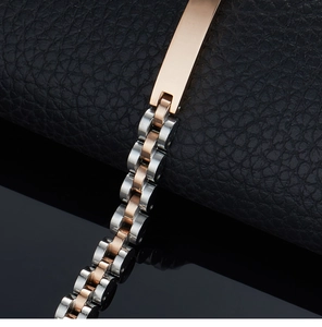 Detail shot of two-tone rose gold and silver stainless steel link bracelet on leather