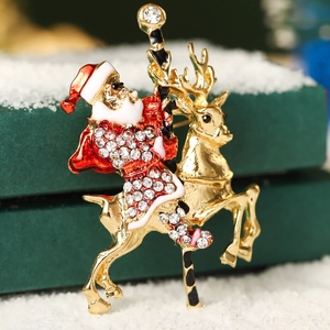 Sparkling Christmas brooch with reindeer and Santa Claus, gold-plated with crystals
