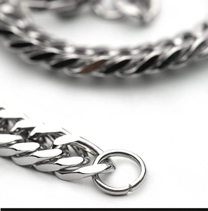 Detailed close-up of a polished titanium steel curb chain link with an open ring closure