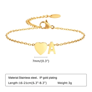 Detail showing IP gold-plated heart pendant and letter A charm with K18 tag on the bracelet