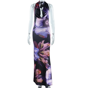 Detailed view of digital floral print and draped deep V-neck on a black halter maxi dress