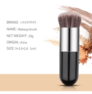 Detailed macro view of soft synthetic bristles and ergonomic round handle of makeup brush
