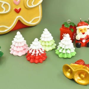 Miniature resin Christmas charms including trees, Santas and gingerbread men for DIY crafts