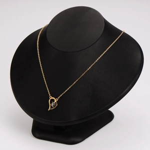 Elegant gold heart necklace featuring asymmetrical black zircon stone on an elegant display