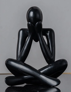 Close-up of black abstract thinking figure sculpture with a smooth matte finish