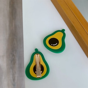 Front and back detail of avocado hair clips with green resin and gold metal alligator grip