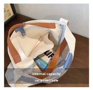 Detailed interior view of a canvas tote bag showing side pockets and large storage space