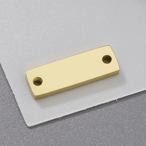 Macro view of a rectangular gold stainless steel charm with dual holes for DIY jewelry