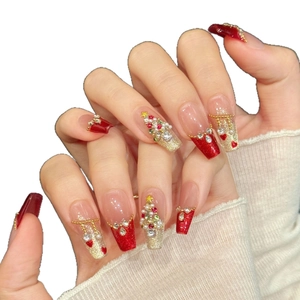 Handmade red and gold Christmas press-on nails with 3D tree and rhinestone heart accents