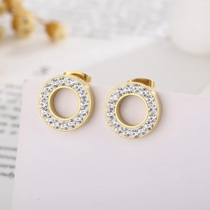 Macro shot of gold circular earrings with pavé set sparkling white cubic zirconia stones
