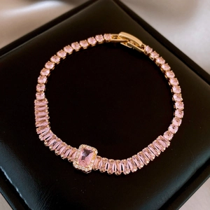 Detailed close-up of a pink oval zircon bracelet with a gold-plated link and clasp