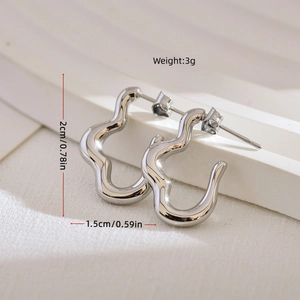 Minimalist irregular wave geometric earrings in silver finish with a polished metal texture